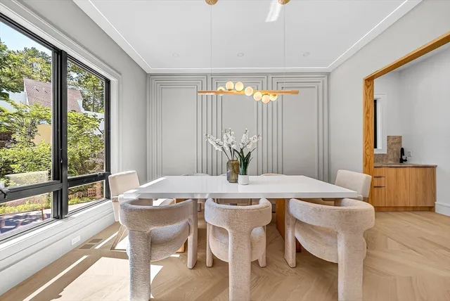 a view of a dining room with furniture window and wooden floor