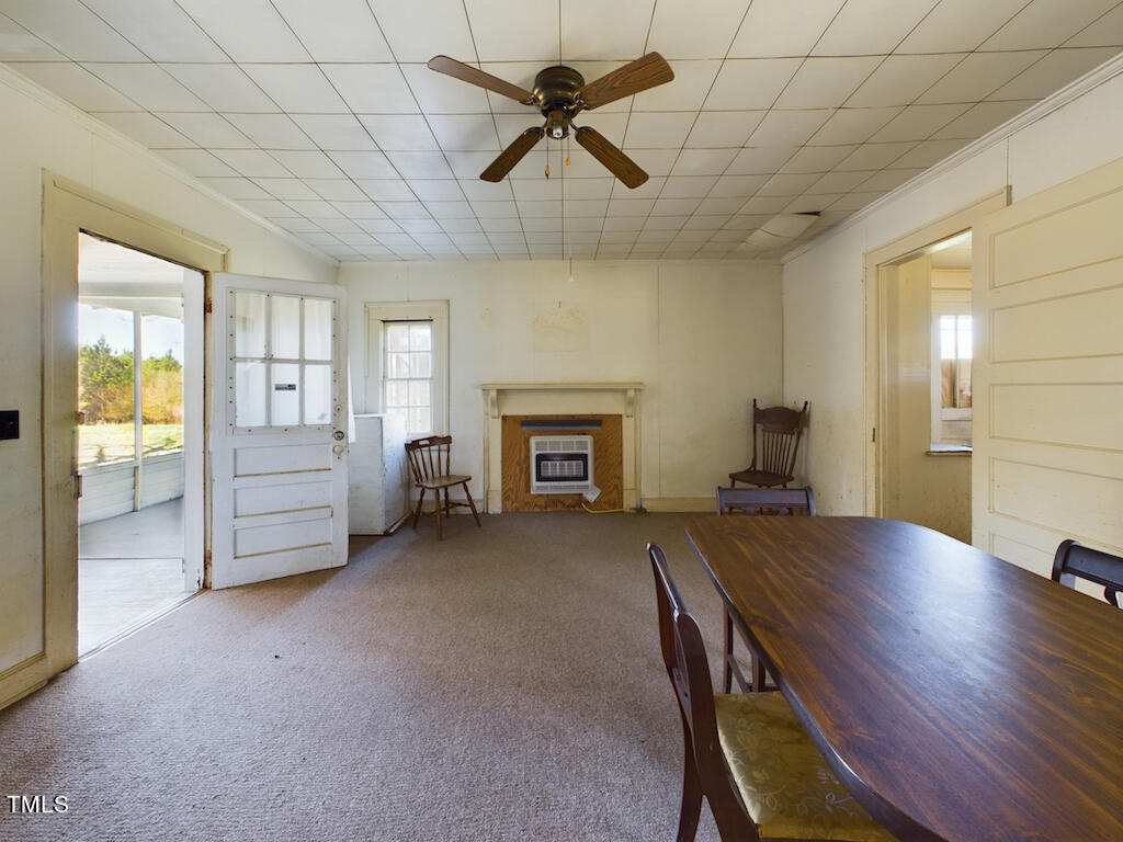 8658 Savage Road Spring Hope, NC 27882 - Photo 18 of 31 a view of an empty room with a fireplace and a window