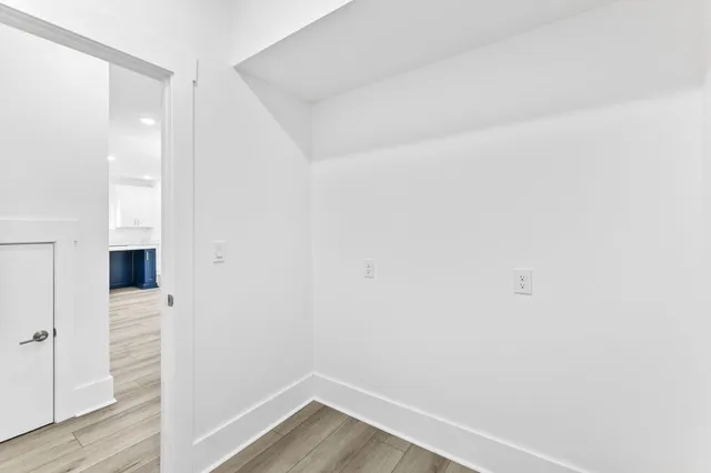 a bathroom with double vanity sink two mirror and a window