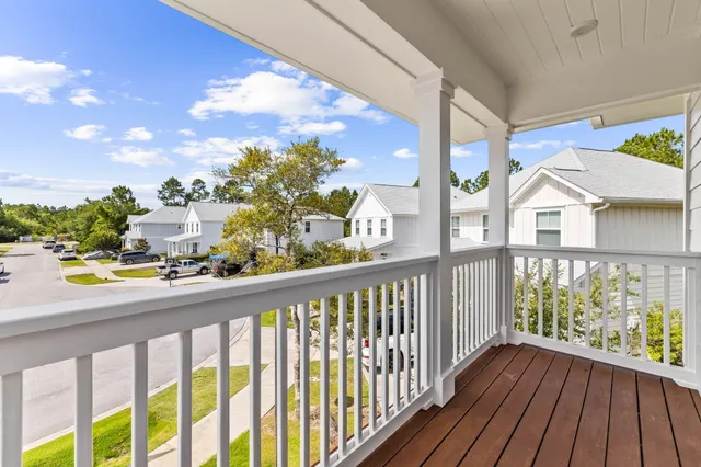 a view of a balcony with wooden floor
