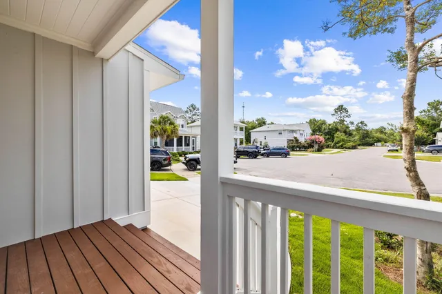 a big room with wooden floor and a chandelier fan