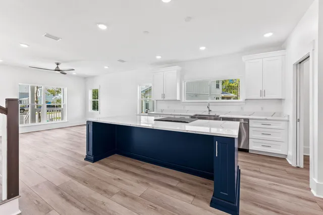 a kitchen with a sink stove and cabinets