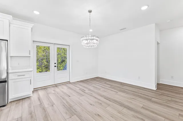 a room with stainless steel appliances kitchen island a large island in the center