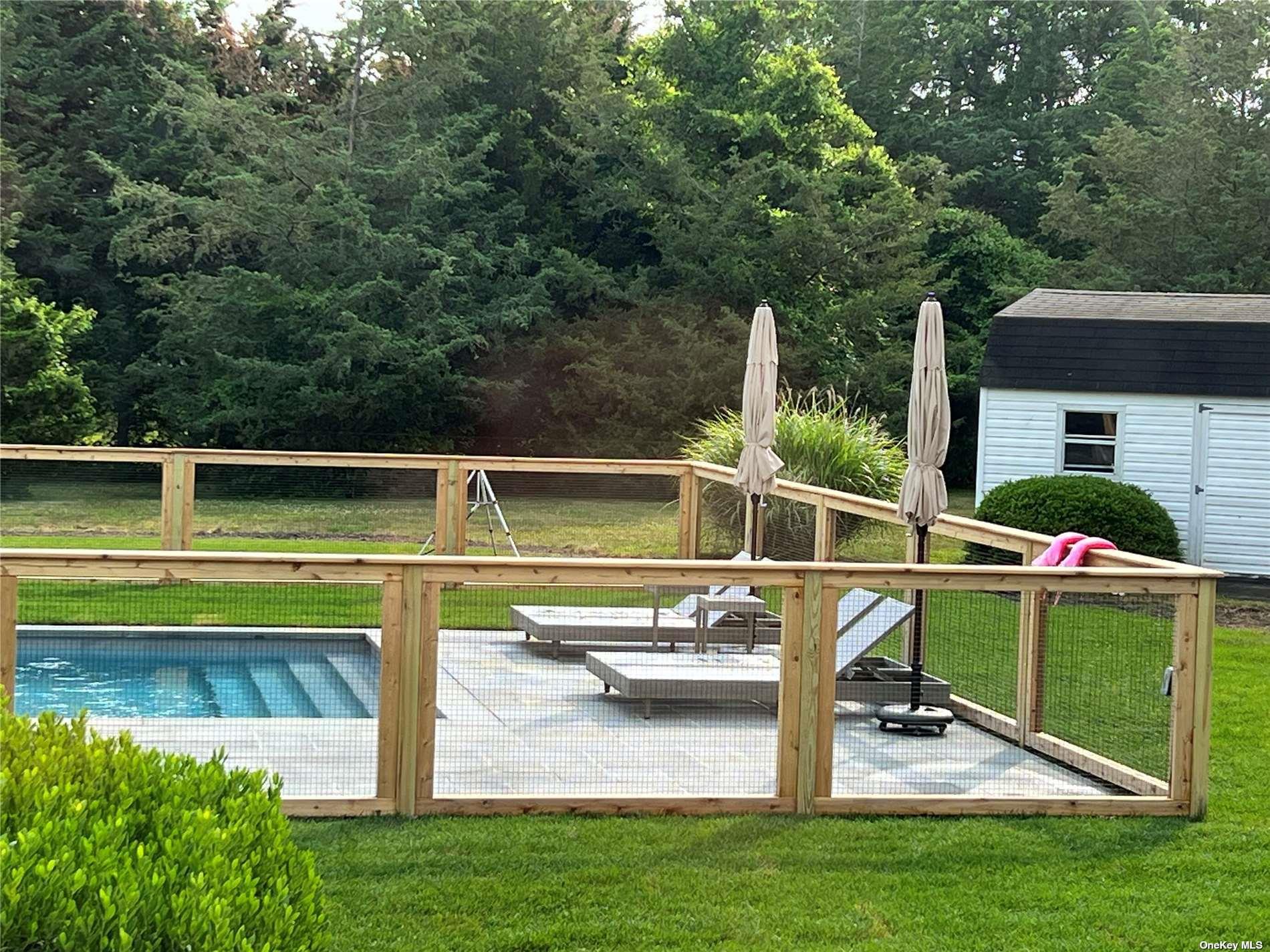 Undisclosed Address Mattituck, NY 11952 - Photo 11 of 35 a view of a swimming pool with a patio