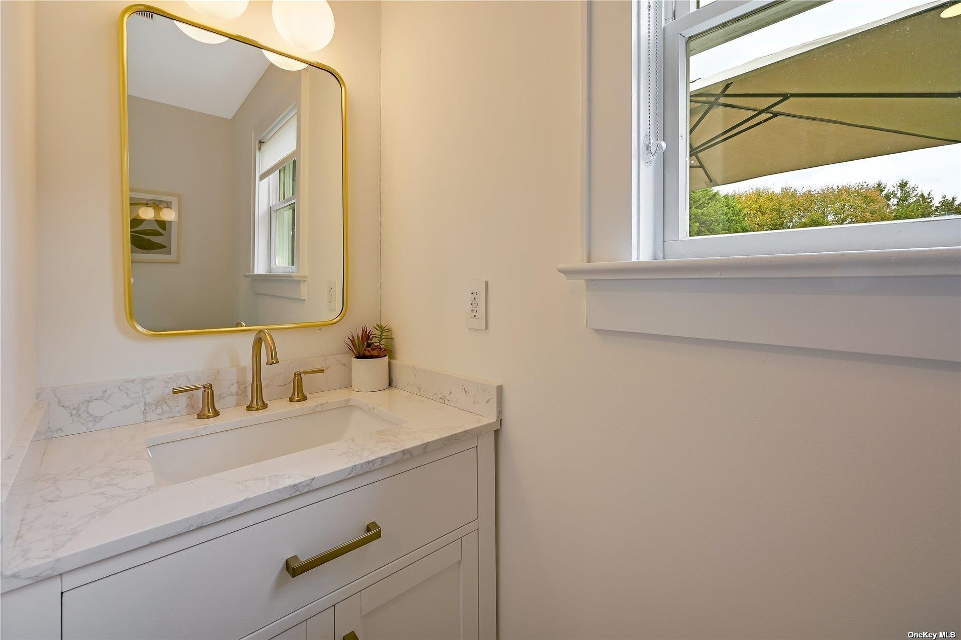 Undisclosed Address Mattituck, NY 11952 - Photo 12 of 35 a bathroom with a sink and a mirror