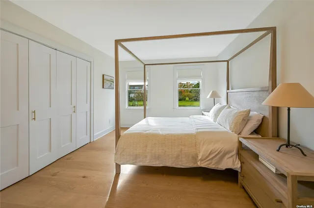 a bedroom with a bed and a lamp