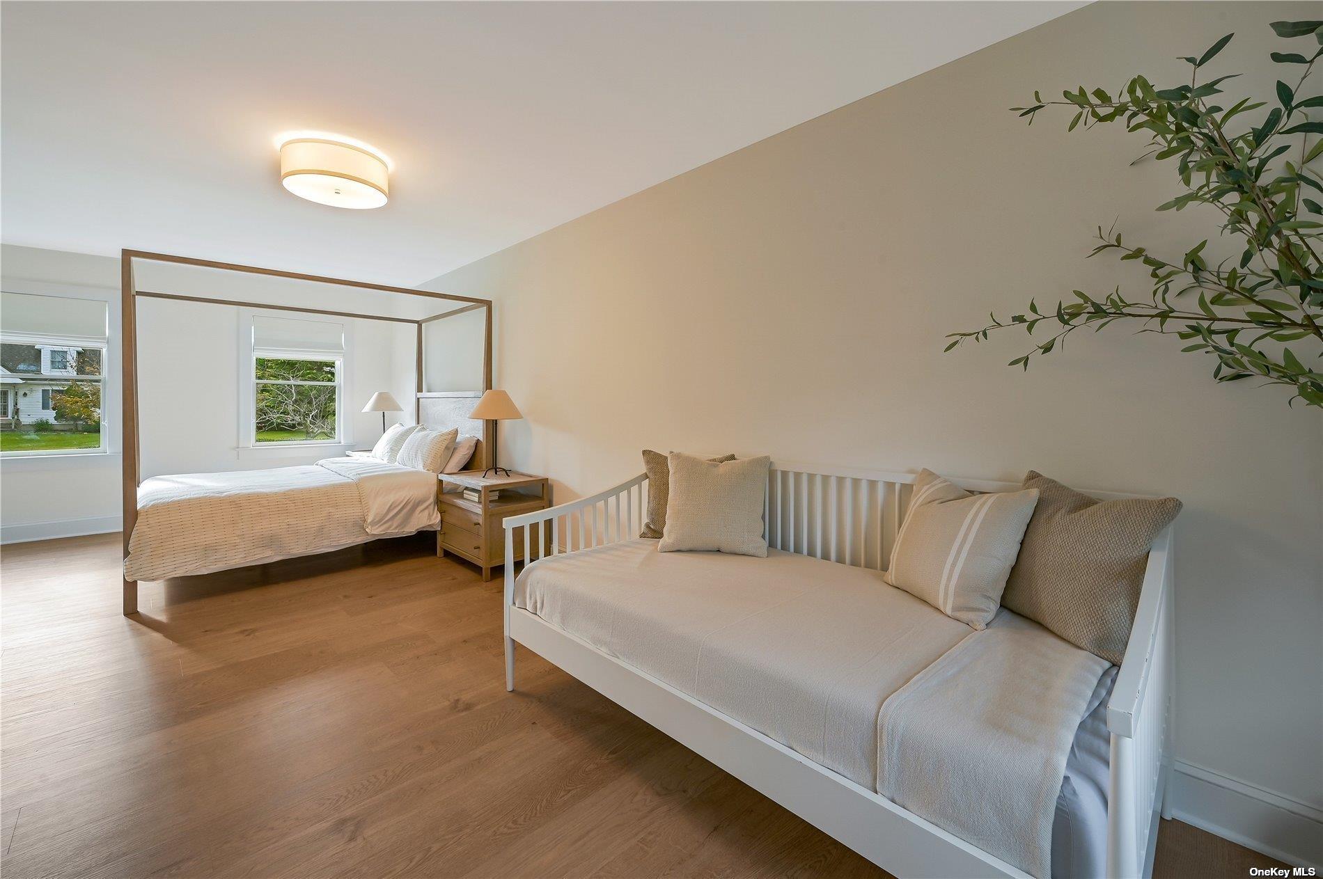 Undisclosed Address Mattituck, NY 11952 - Photo 15 of 35 a bed room with a bed and a couch