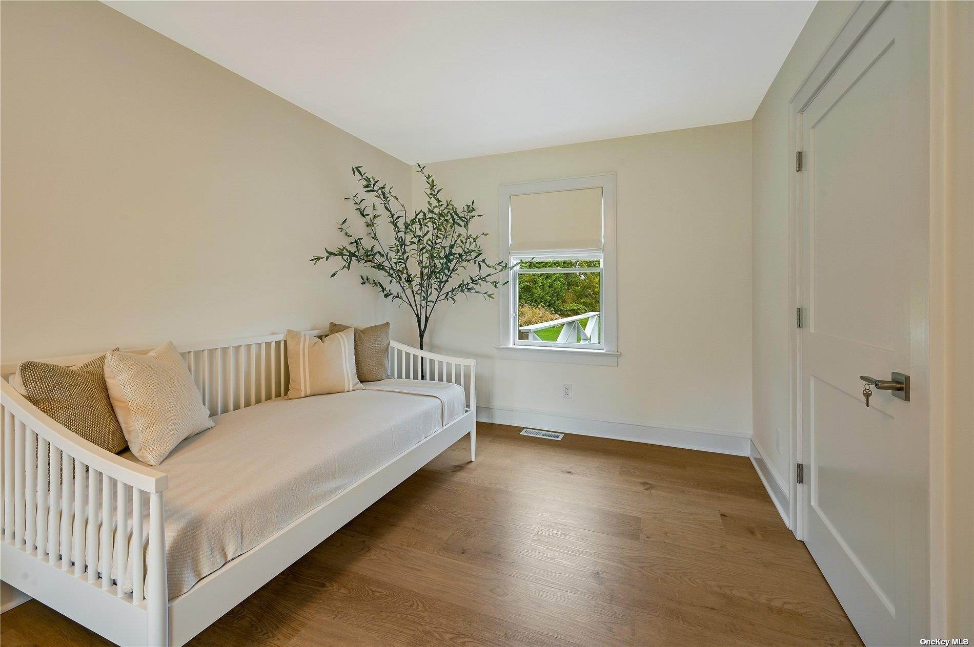 Undisclosed Address Mattituck, NY 11952 - Photo 16 of 35 a bedroom with a bed and a window