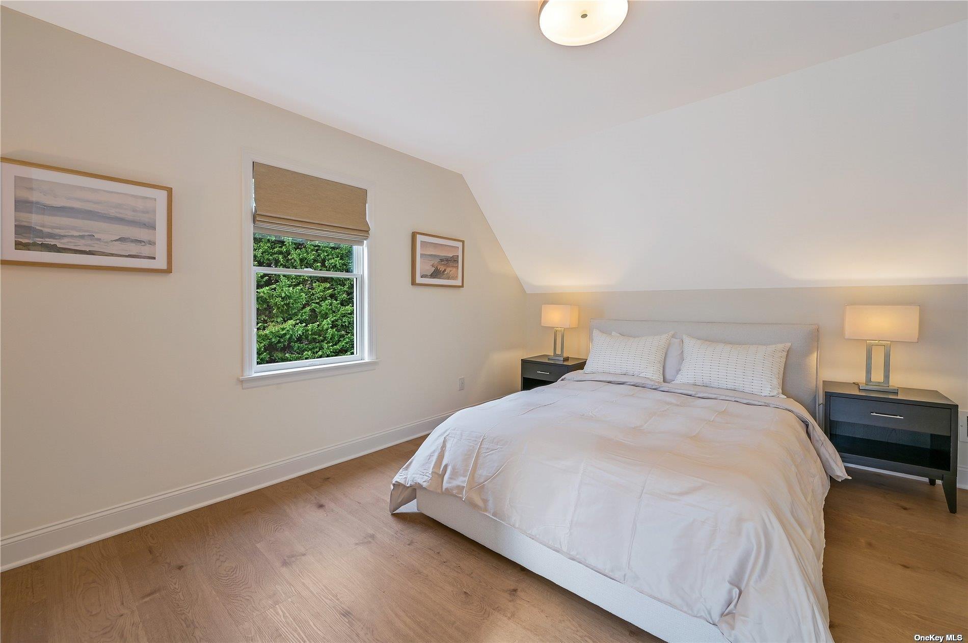 Undisclosed Address Mattituck, NY 11952 - Photo 19 of 35 a bedroom with a bed and a window