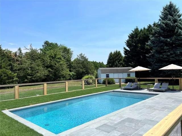 a view of a swimming pool with a yard