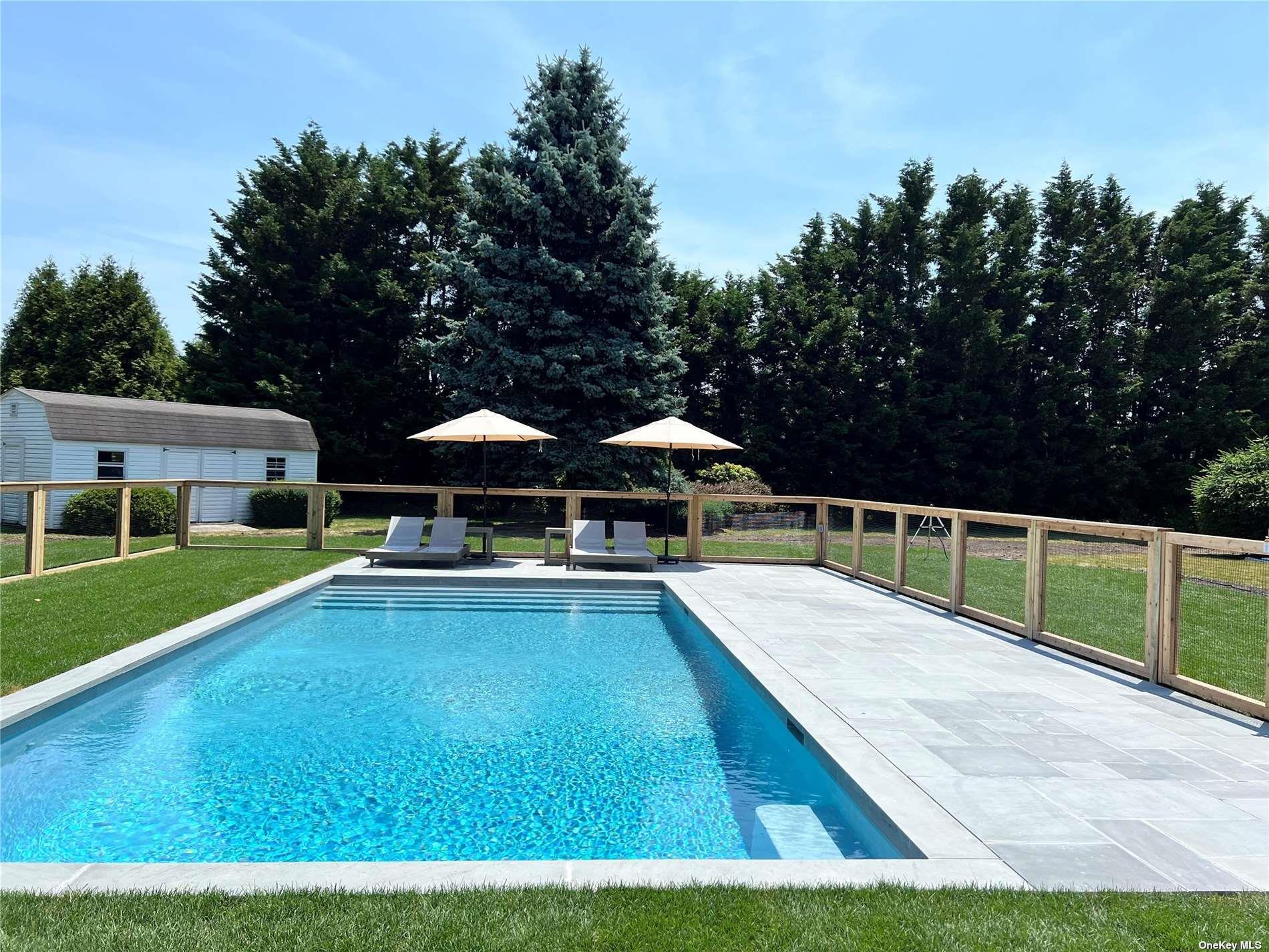 Undisclosed Address Mattituck, NY 11952 - Photo 22 of 35 a view of a swimming pool with a yard