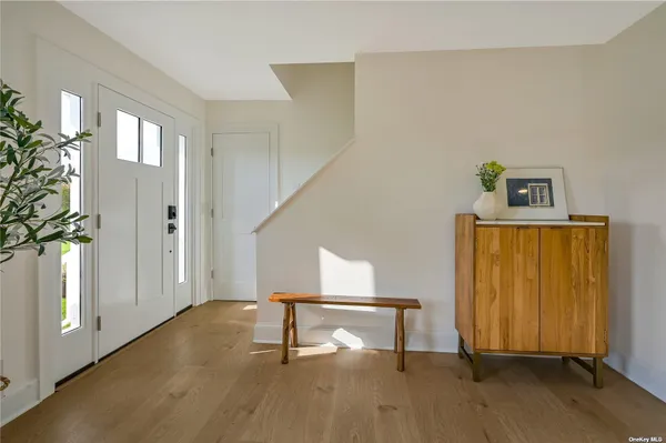 a view of an entryway with wooden floor