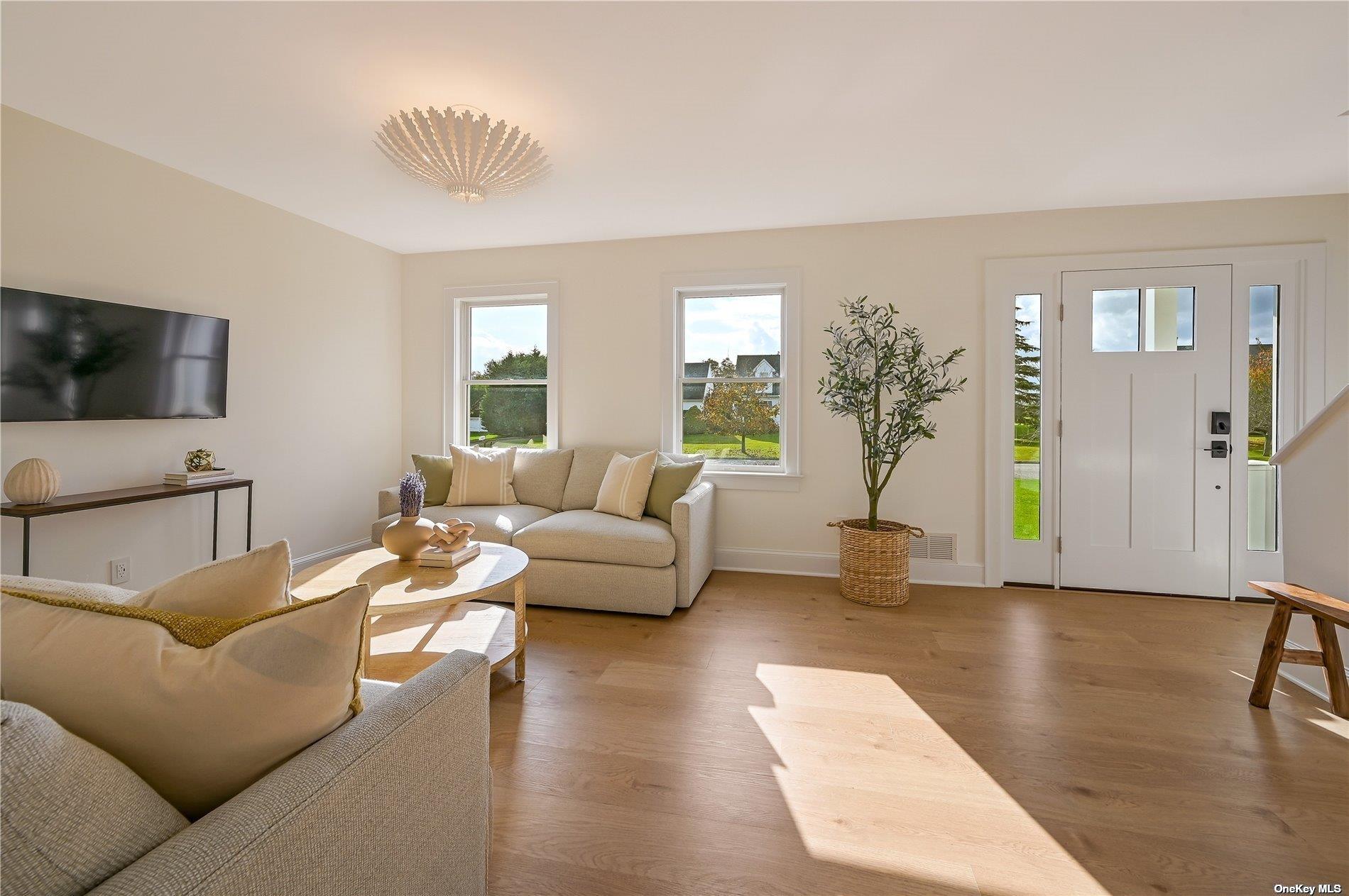 Undisclosed Address Mattituck, NY 11952 - Photo 4 of 35 a living room with furniture and a flat screen tv