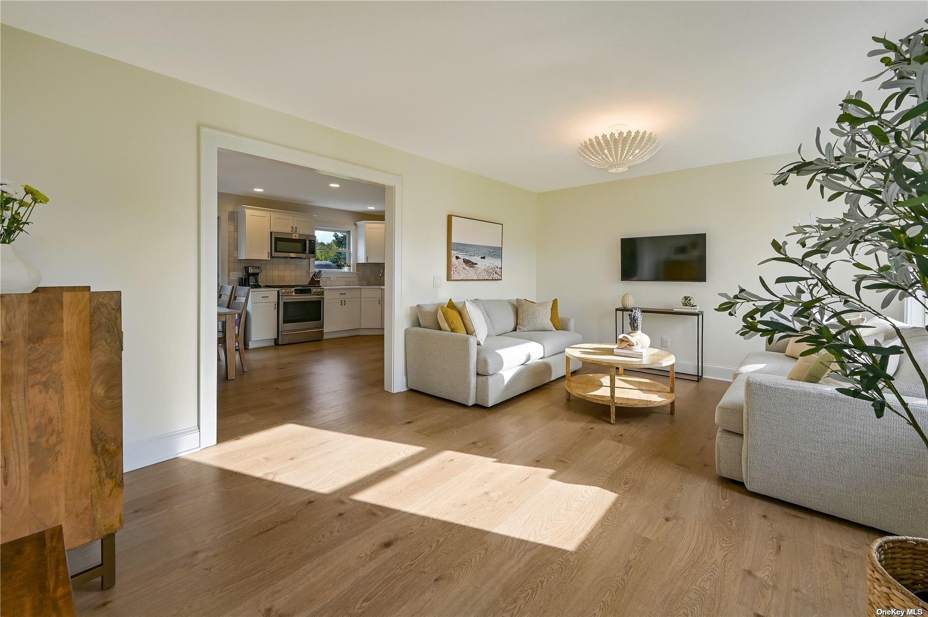 Undisclosed Address Mattituck, NY 11952 - Photo 6 of 35 a living room with furniture and a flat screen tv