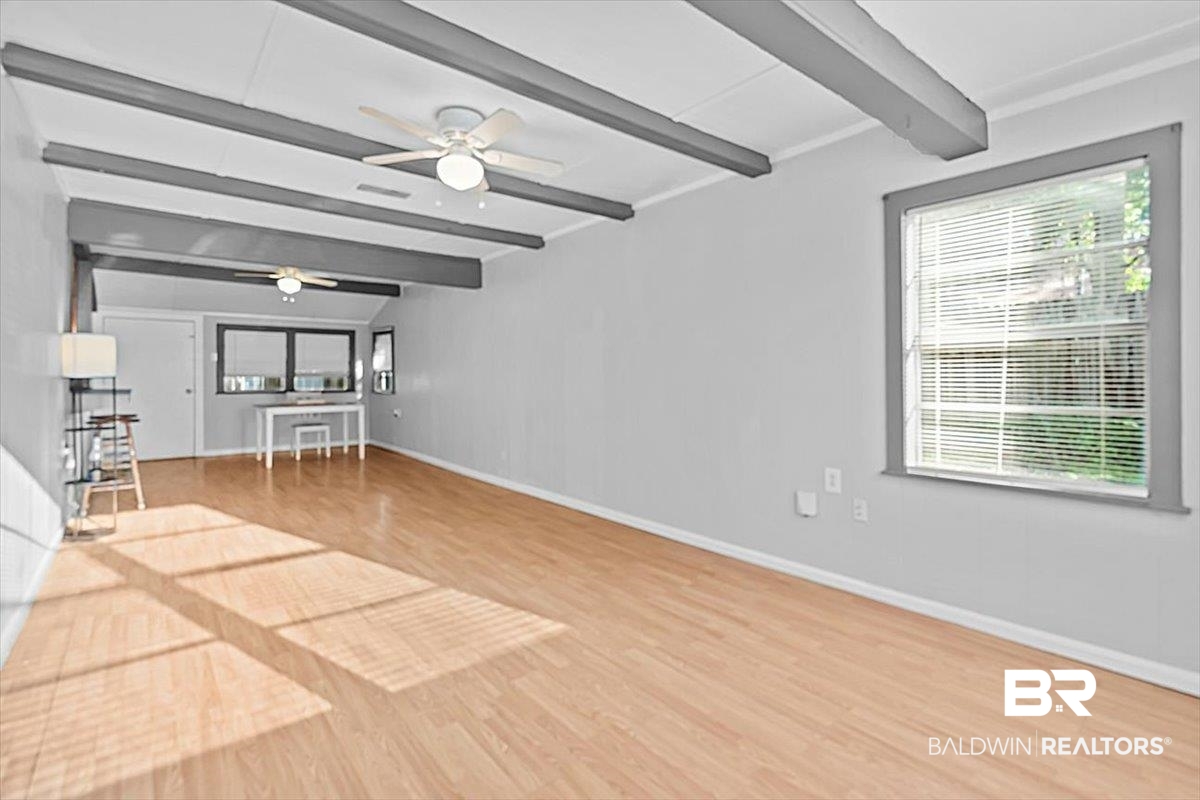 4918 Quimby Drive Mobile, AL 36619 - Photo 5 of 38 Unfurnished living room with beamed ceiling, a ceiling fan, wood finished floors, and baseboards
