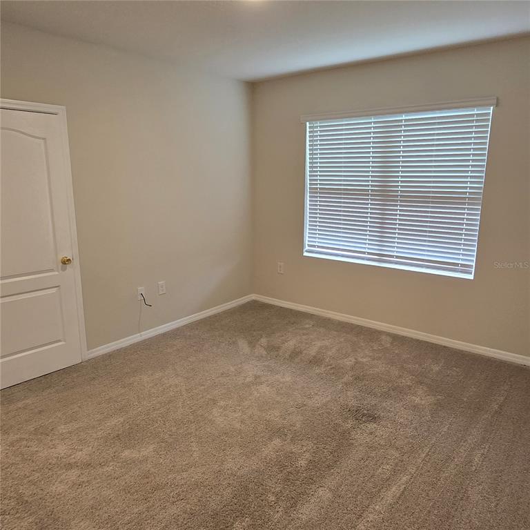 814 Sun Burst Road Winter Haven, FL 33880 - Photo 39 of 48 an empty room with a window