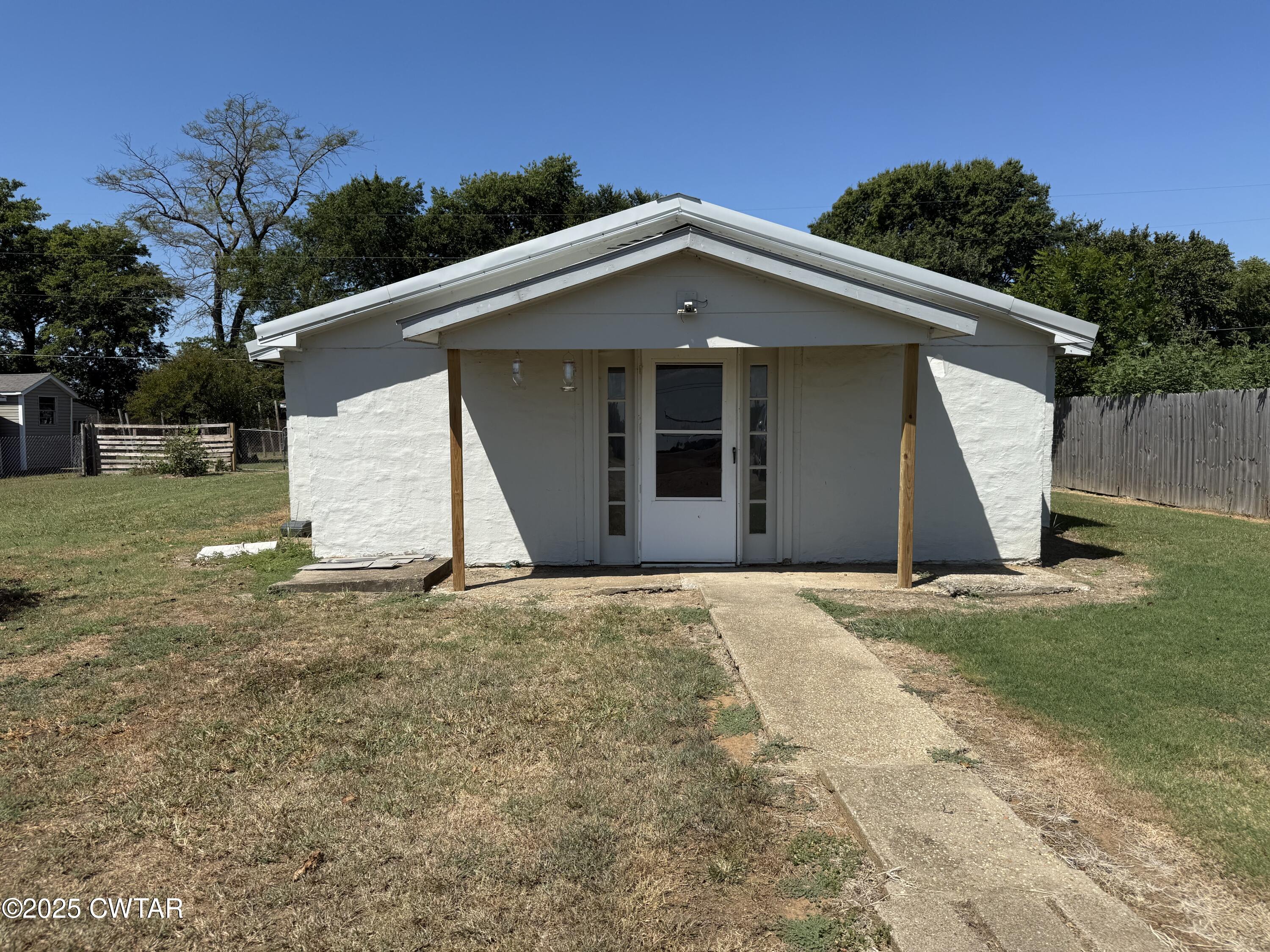 a view of a house with a yard and garage