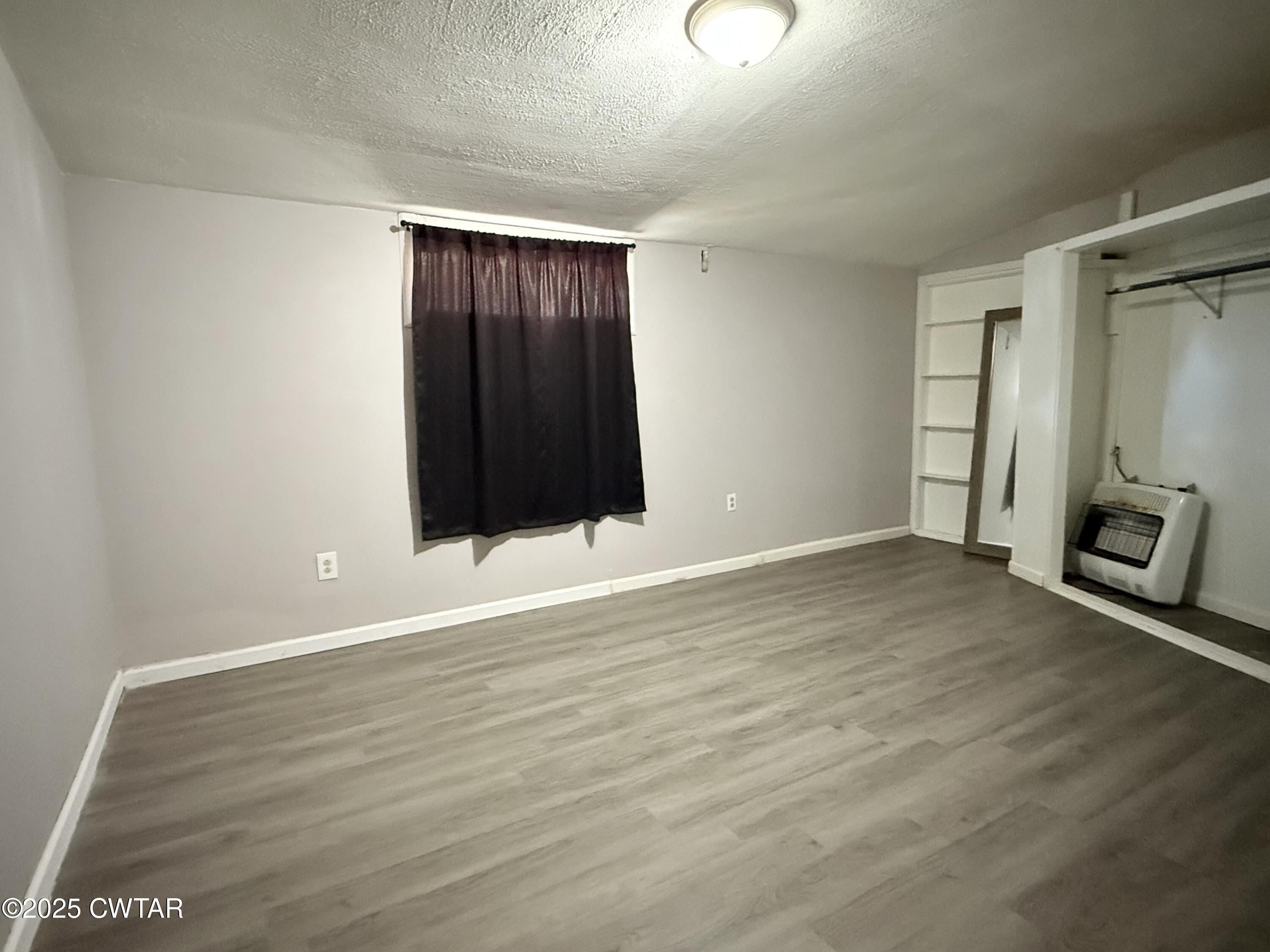 4010 Highway 78 Ridgely, TN 38080 - Photo 13 of 21 a view of an empty room with wooden floor and a window