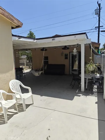 a view of a patio with table and chairs and potted plants
