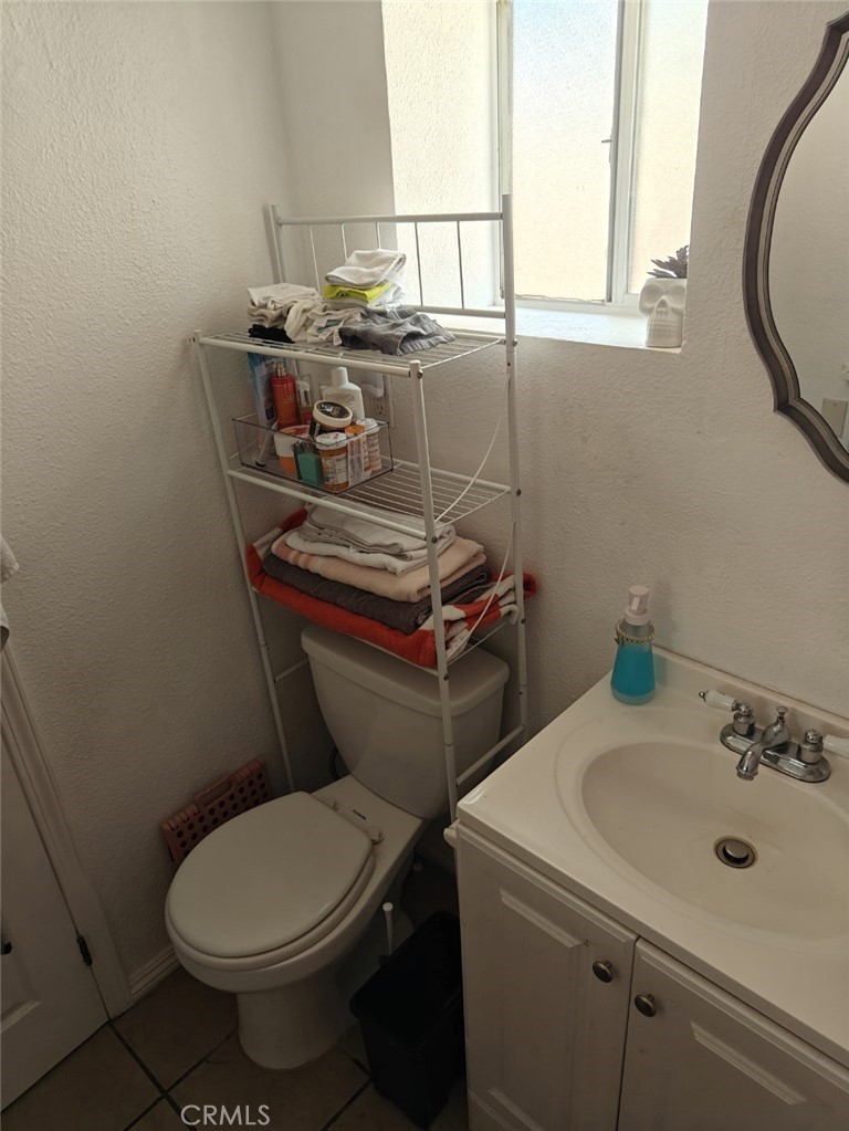 2428 Vasquez Place Riverside, CA 92507 - Photo 10 of 25 a bathroom with a sink a toilet and a mirror