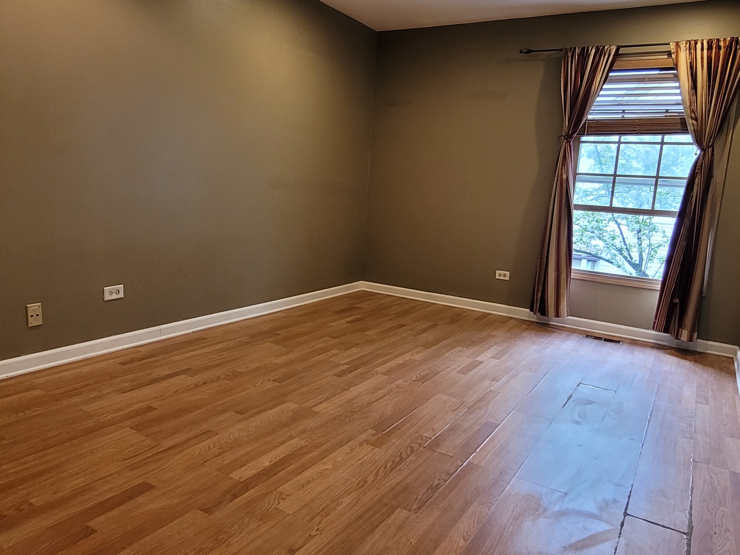 306 Inverrary Lane Deerfield, IL 60015 - Photo 11 of 23 an empty room with wooden floor and windows