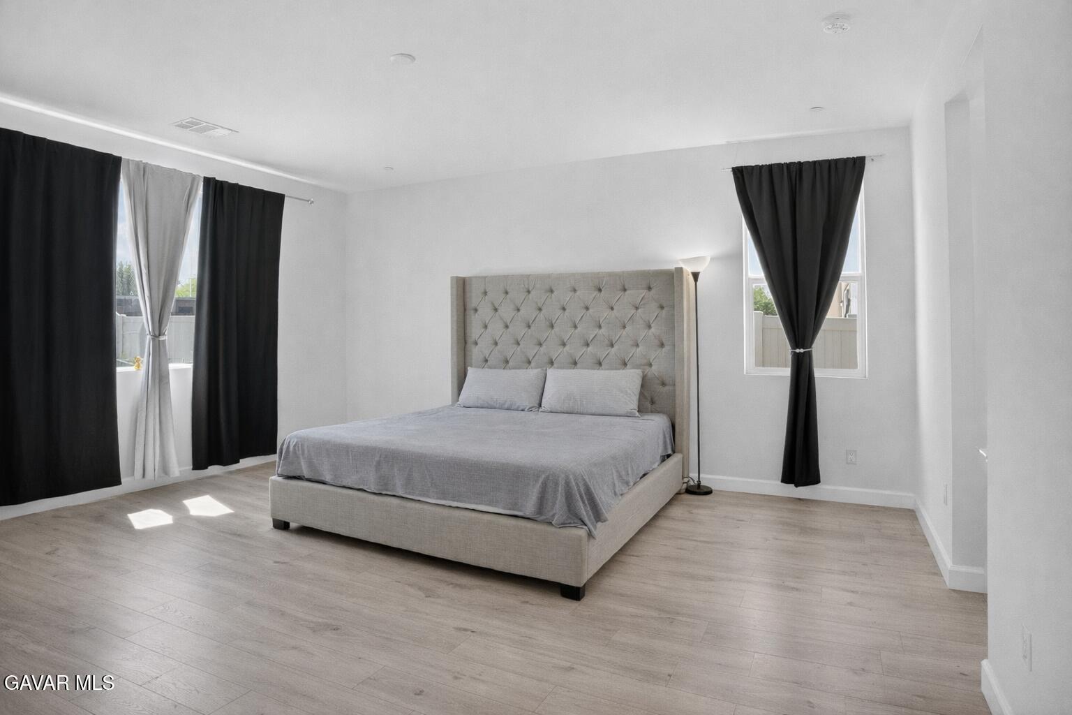 38018 Periwinkle Place Palmdale, CA 93550 - Photo 11 of 32 a bedroom with a bed and a painting on the wall
