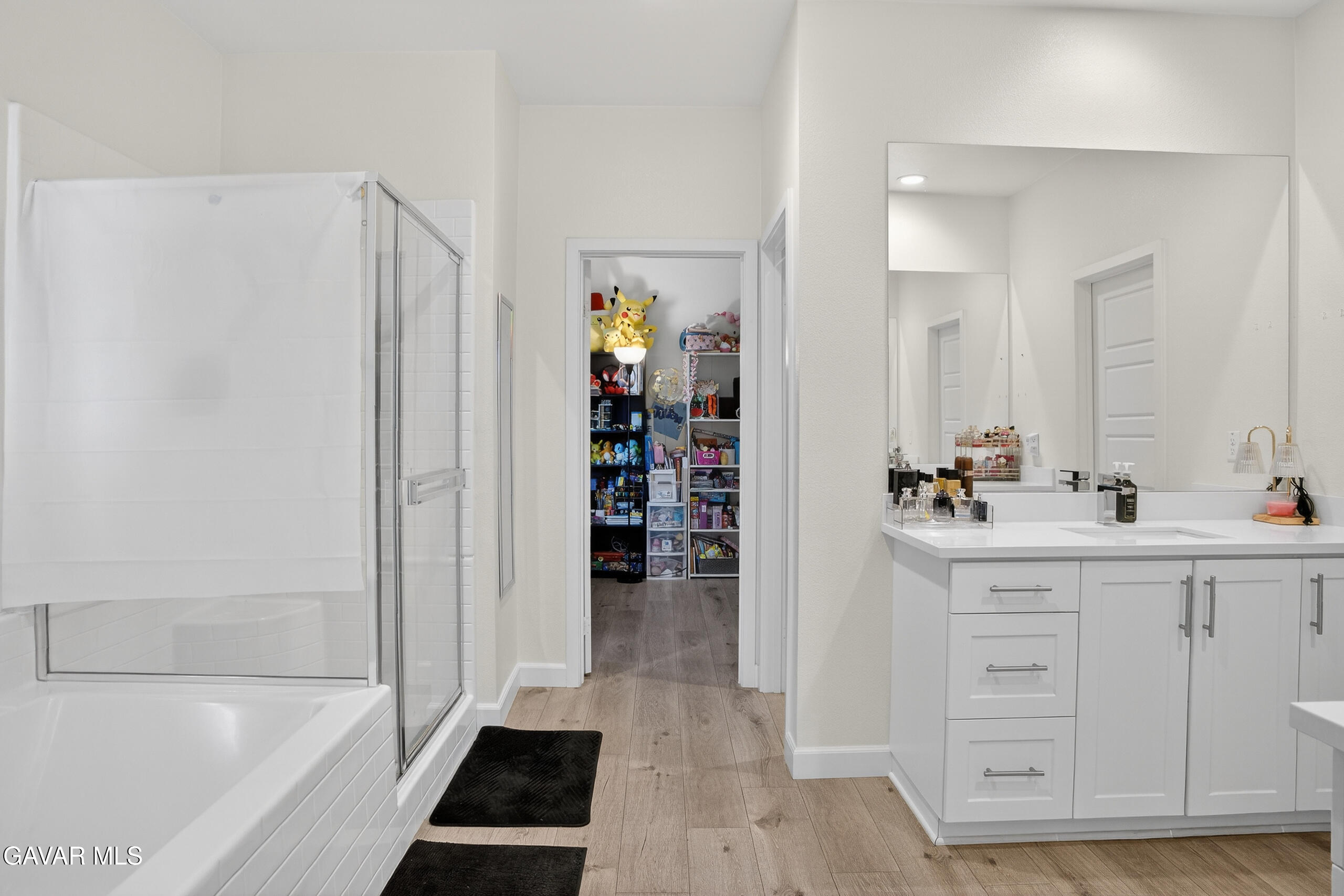 38018 Periwinkle Place Palmdale, CA 93550 - Photo 17 of 32 a bathroom with a bathtub sink vanity and mirror