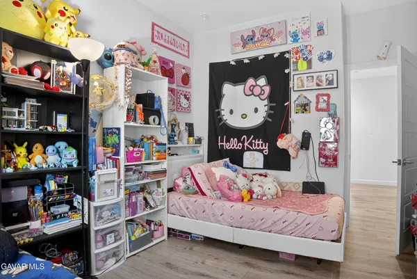 a bedroom with baby toys and a book shelf
