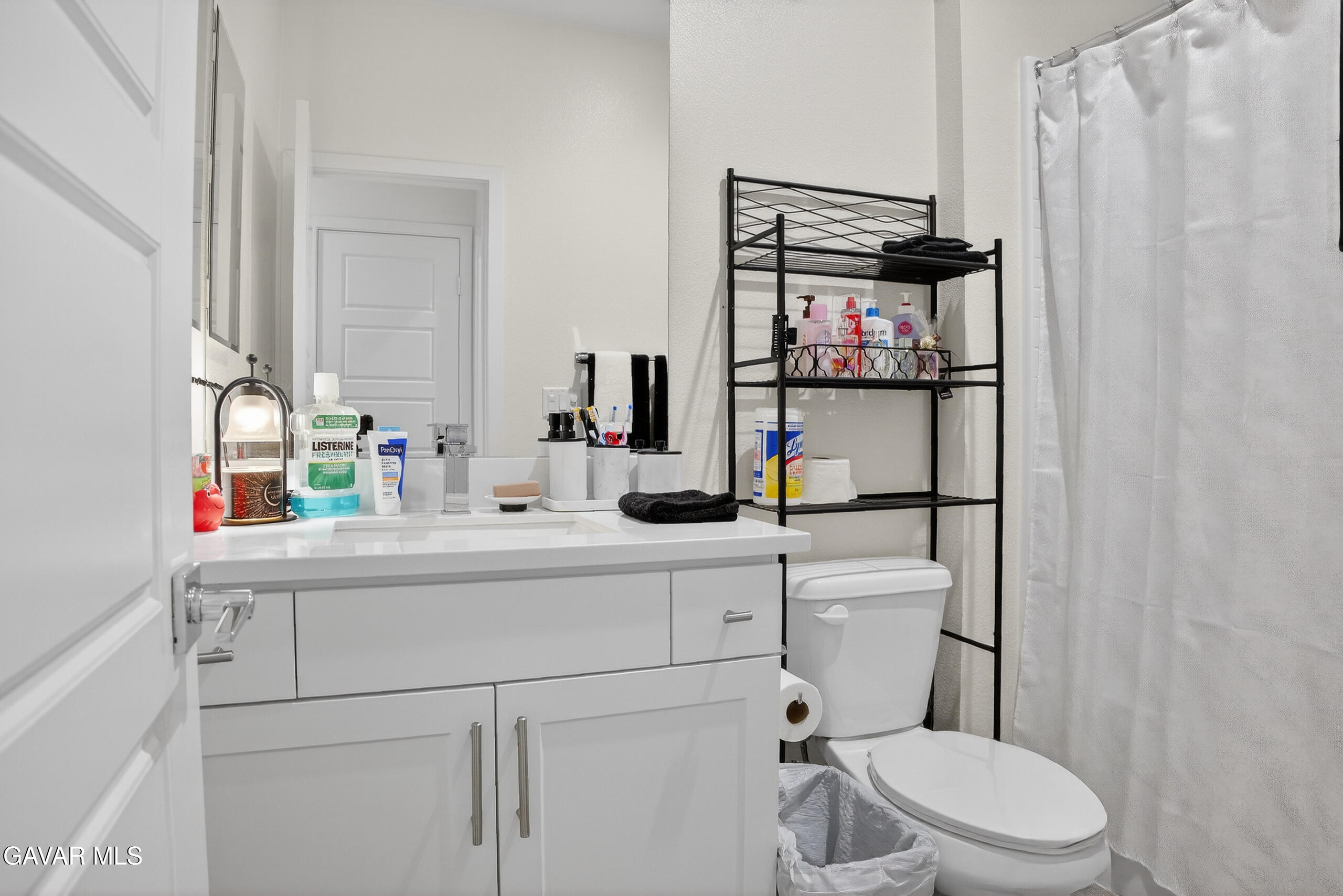 38018 Periwinkle Place Palmdale, CA 93550 - Photo 19 of 32 a bathroom with a sink vanity mirror and toilet