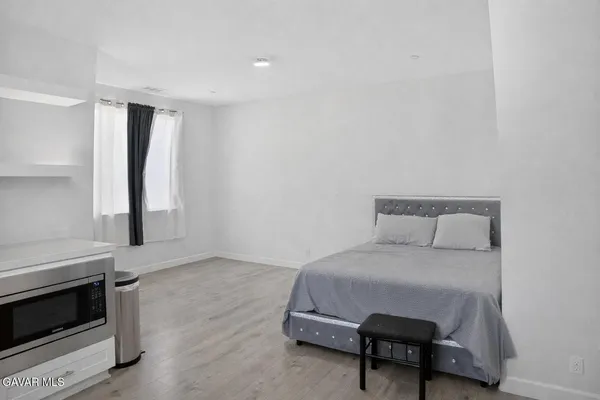 a bedroom with furniture and a wooden floor