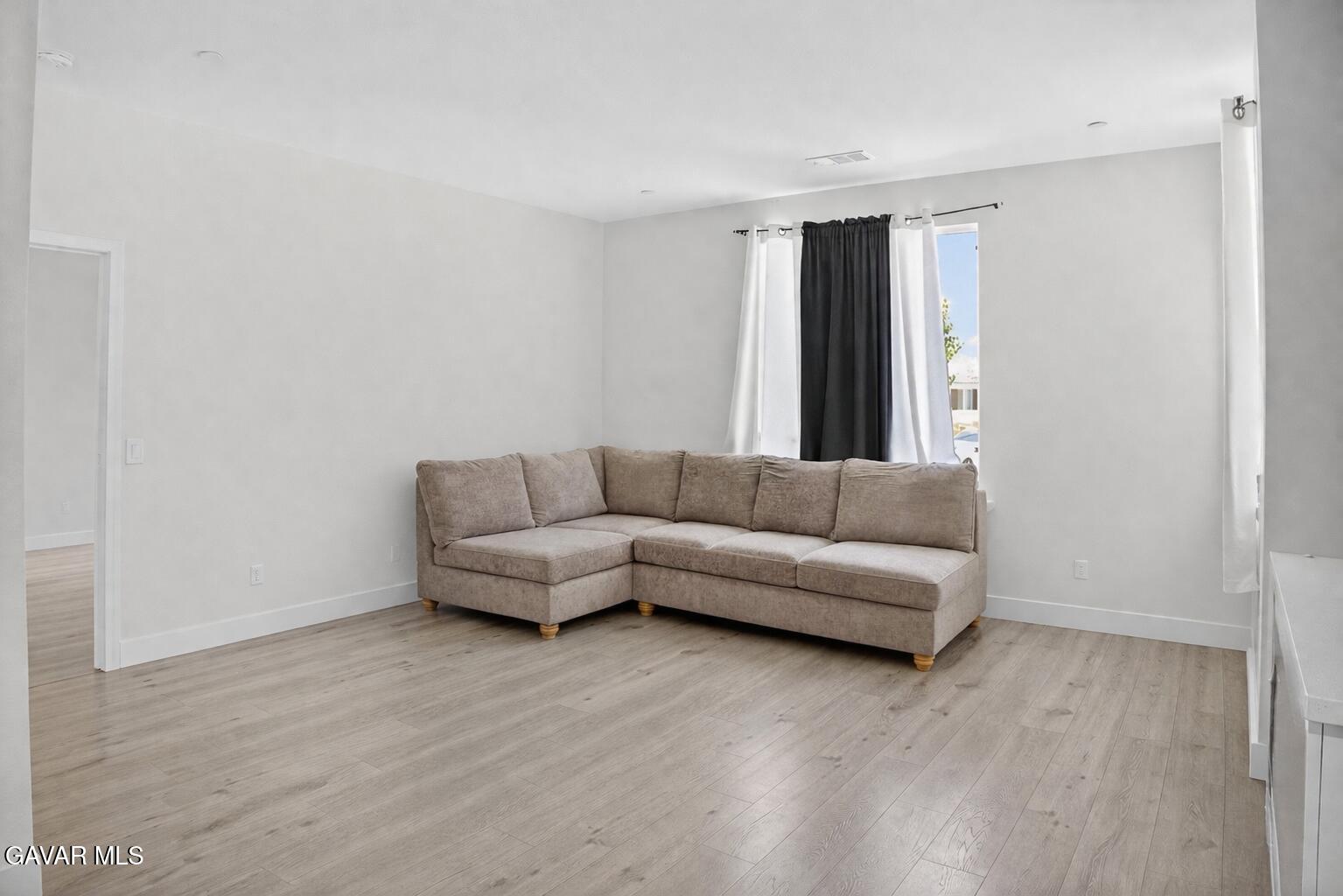 38018 Periwinkle Place Palmdale, CA 93550 - Photo 26 of 32 a living room with furniture and a wooden floor