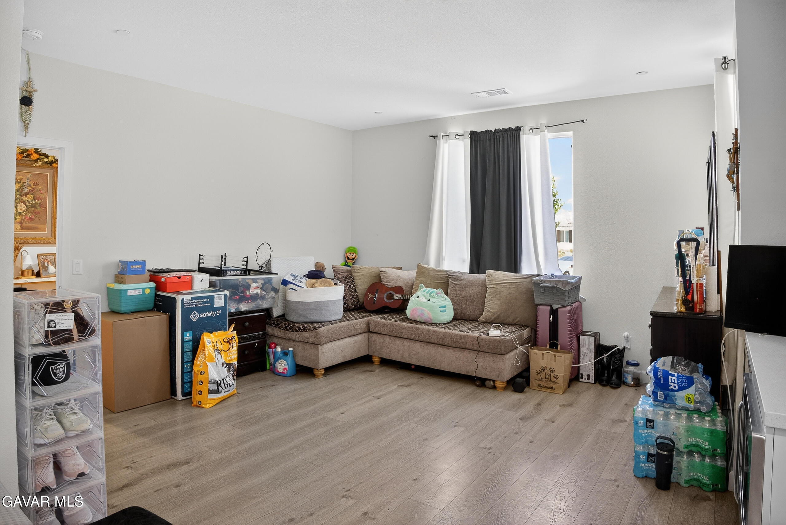 38018 Periwinkle Place Palmdale, CA 93550 - Photo 27 of 32 a living room with furniture and a flat screen tv
