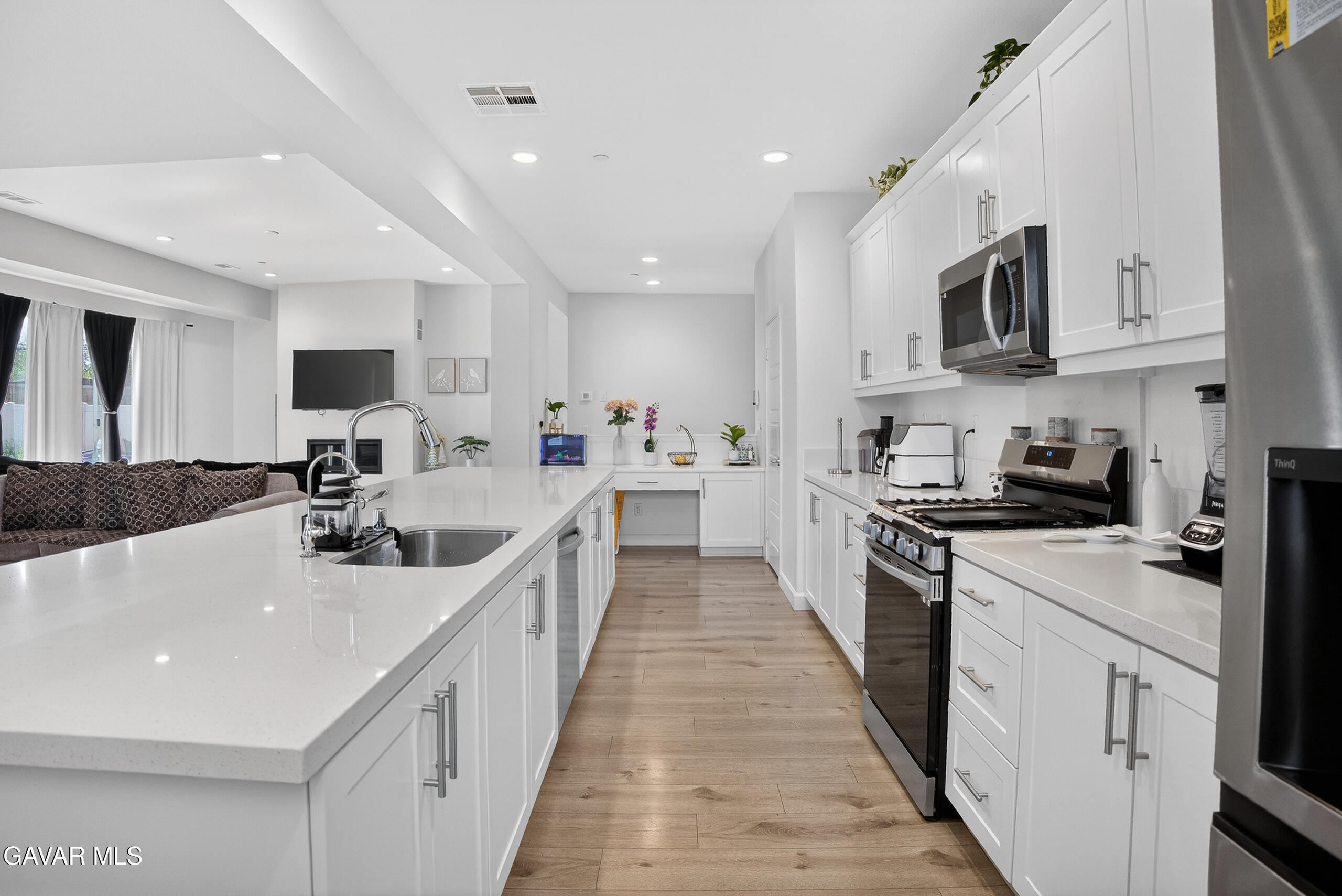 38018 Periwinkle Place Palmdale, CA 93550 - Photo 5 of 32 a large white kitchen with stainless steel appliances