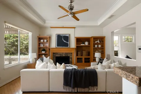 a living room with furniture a fireplace and a floor to ceiling window