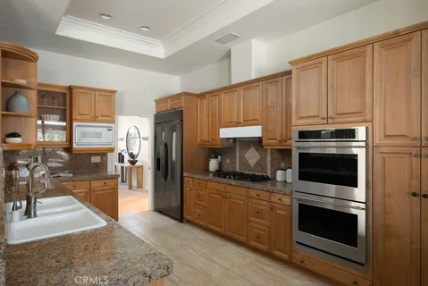 a kitchen with granite countertop a refrigerator stove and washer