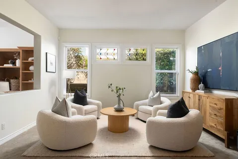 a living room with furniture and a floor to ceiling window