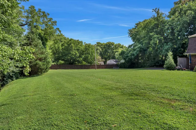 a view of a garden with a house