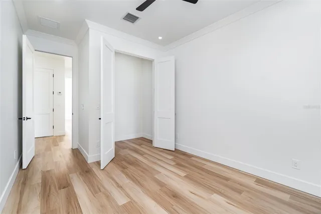 a view of a room with wooden floor