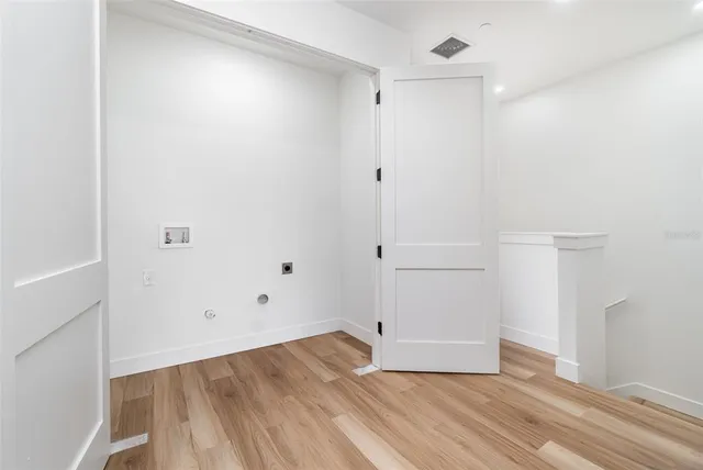 an empty room with wooden floor