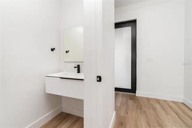 a view of utility room with wooden floor