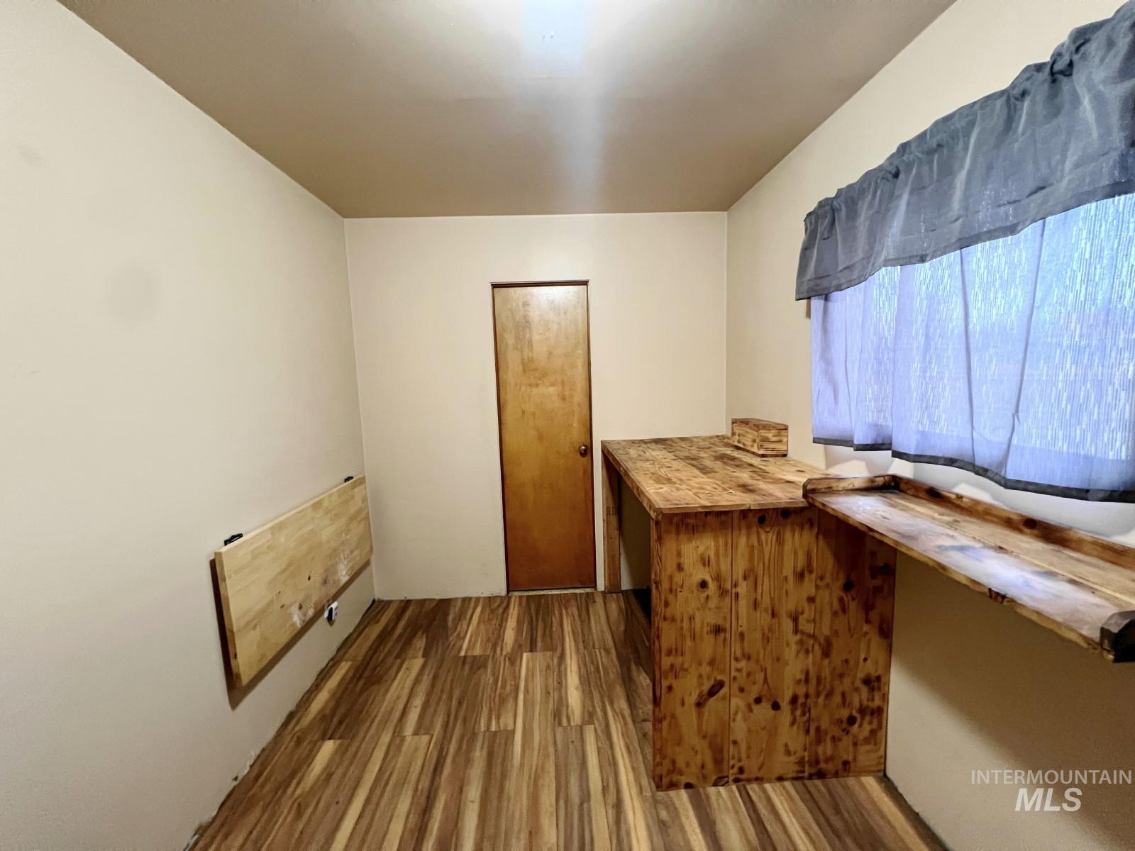 603 Maple Street Nezperce, ID 83543 - Photo 17 of 26 Bar featuring dark wood-type flooring and wooden counters