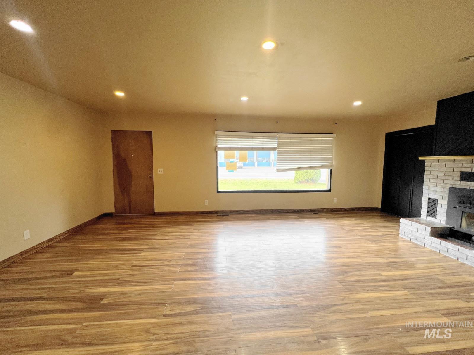 603 Maple Street Nezperce, ID 83543 - Photo 2 of 26 Unfurnished living room with recessed lighting and light wood finished floors