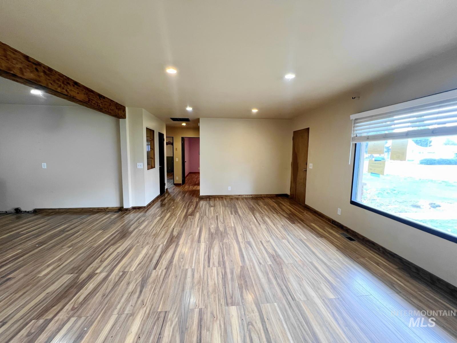 603 Maple Street Nezperce, ID 83543 - Photo 4 of 26 Spare room with recessed lighting, wood finished floors, and beamed ceiling