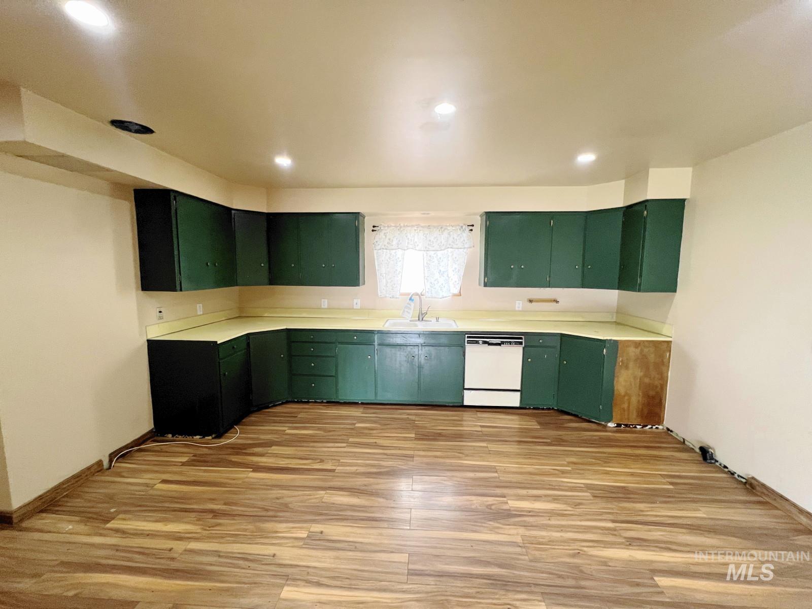 603 Maple Street Nezperce, ID 83543 - Photo 7 of 26 Kitchen featuring green cabinets, light wood-style floors, light countertops, and recessed lighting