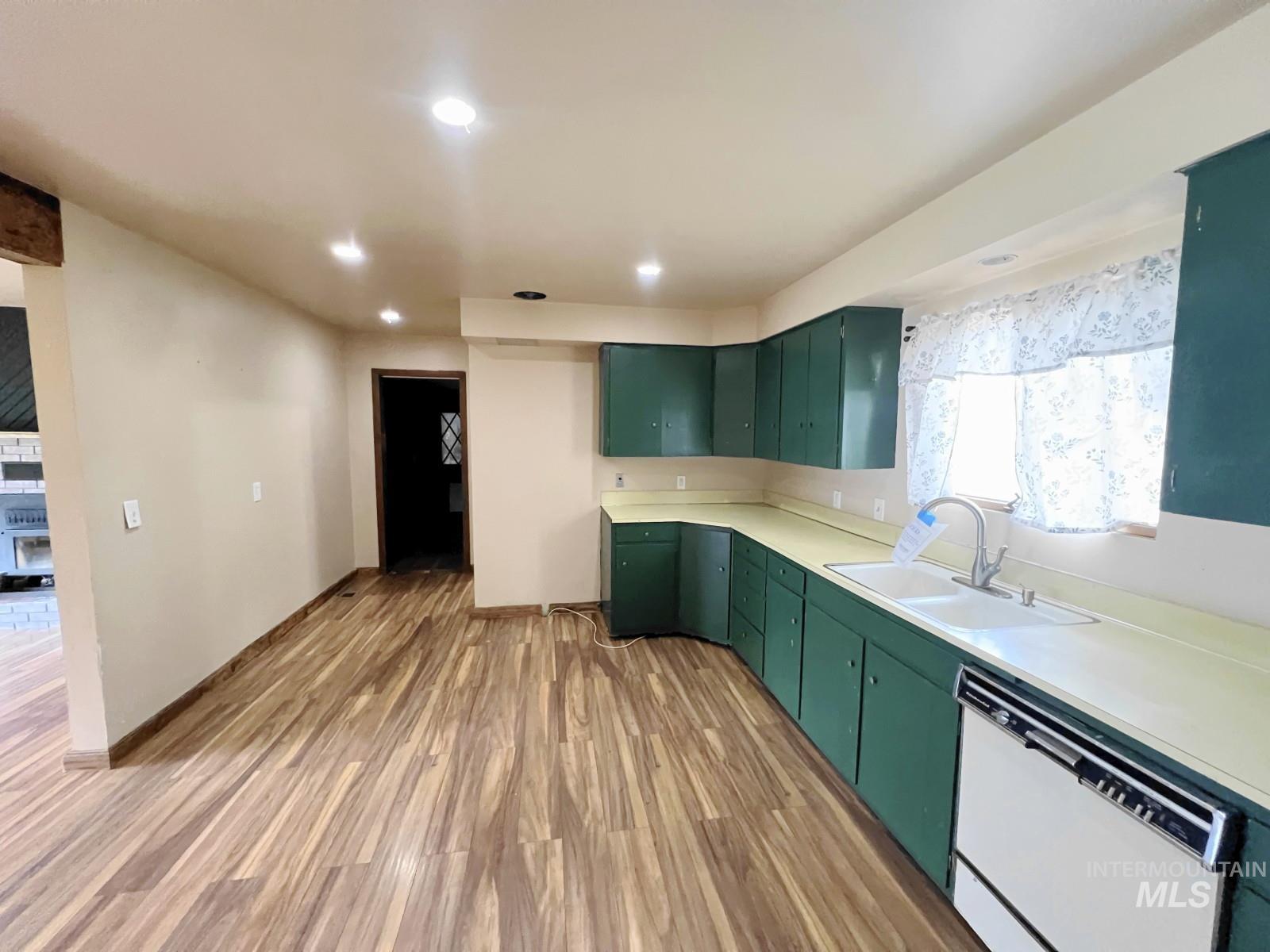 603 Maple Street Nezperce, ID 83543 - Photo 8 of 26 Kitchen with dishwasher, light wood finished floors, light countertops, green cabinetry, and recessed lighting
