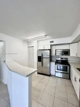 a kitchen with a stove and a refrigerator