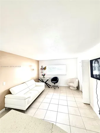 a living room with a bed and a table