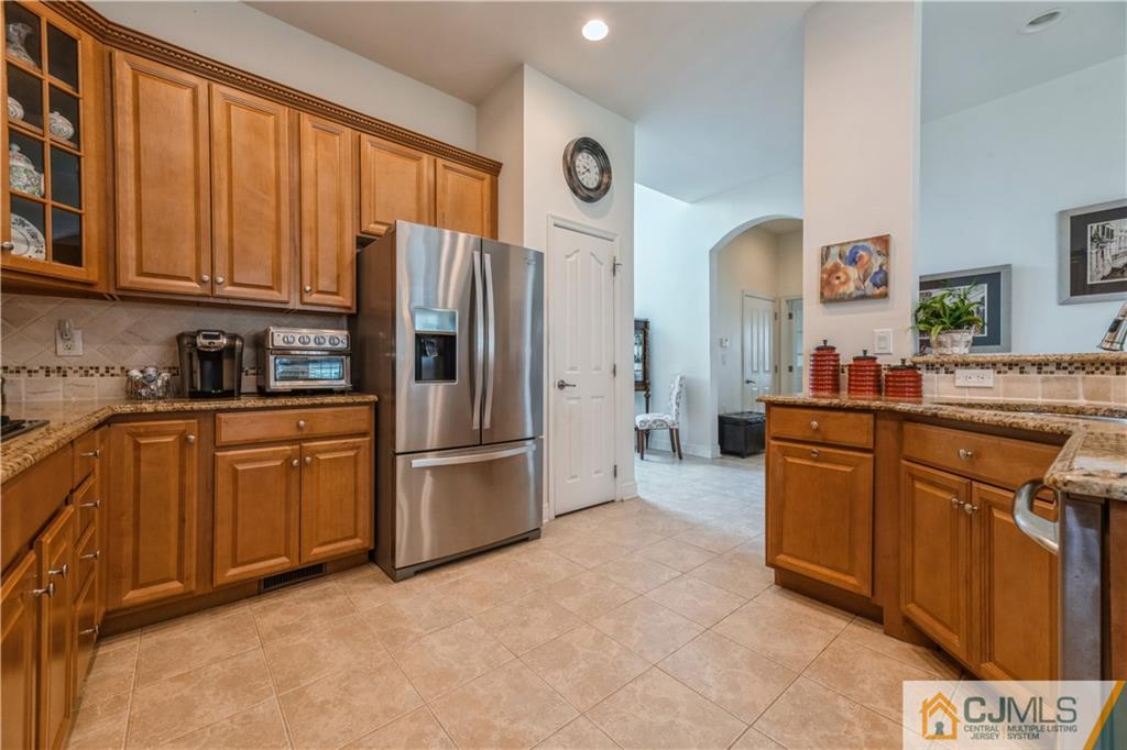 18 Mandrake Road Monroe Township, NJ 08831 - Photo 13 of 44 a kitchen with granite countertop a refrigerator stove top oven and sink