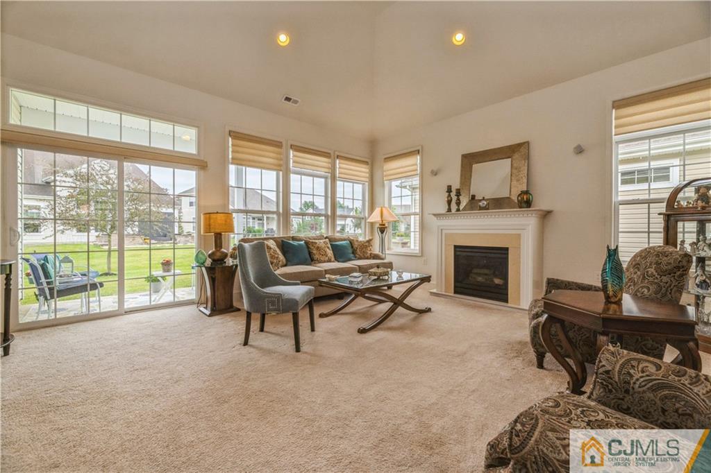 18 Mandrake Road Monroe Township, NJ 08831 - Photo 16 of 44 a living room with furniture and a fireplace