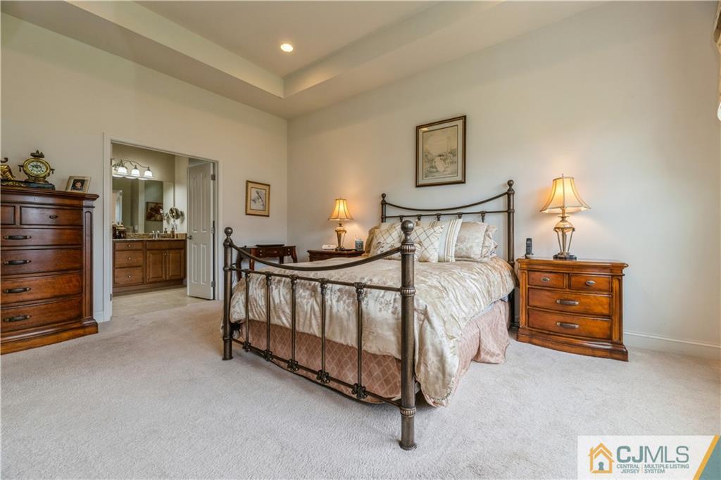18 Mandrake Road Monroe Township, NJ 08831 - Photo 21 of 44 a bedroom with a bed and a chandelier
